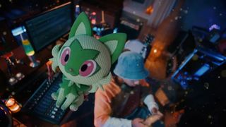 a sprigatito plushie erupting from a switch