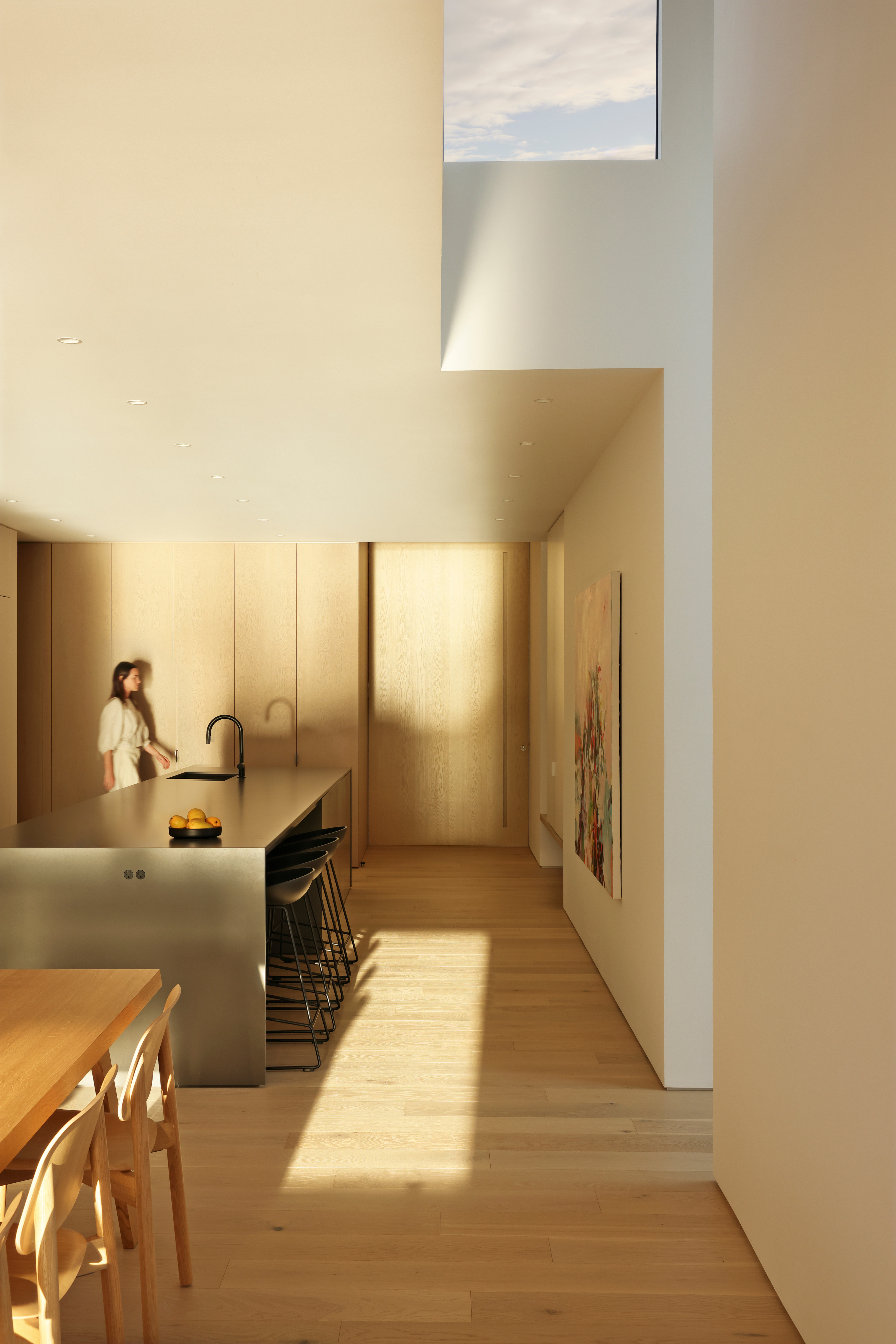 Looking back to the front door past the dining area and kitchen island