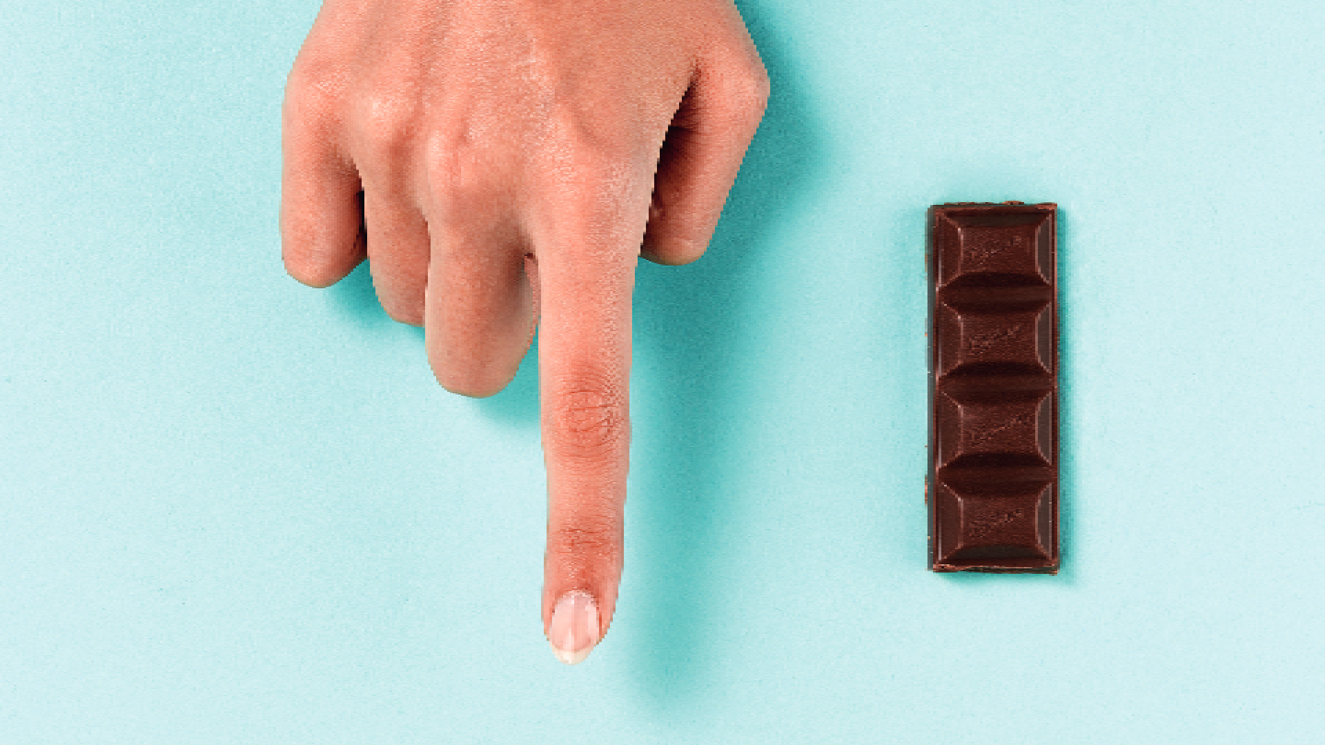 finger next to chocolate
