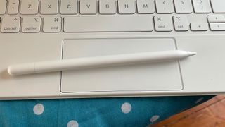Apple Pencil USB-C on a white Magic Keyboard