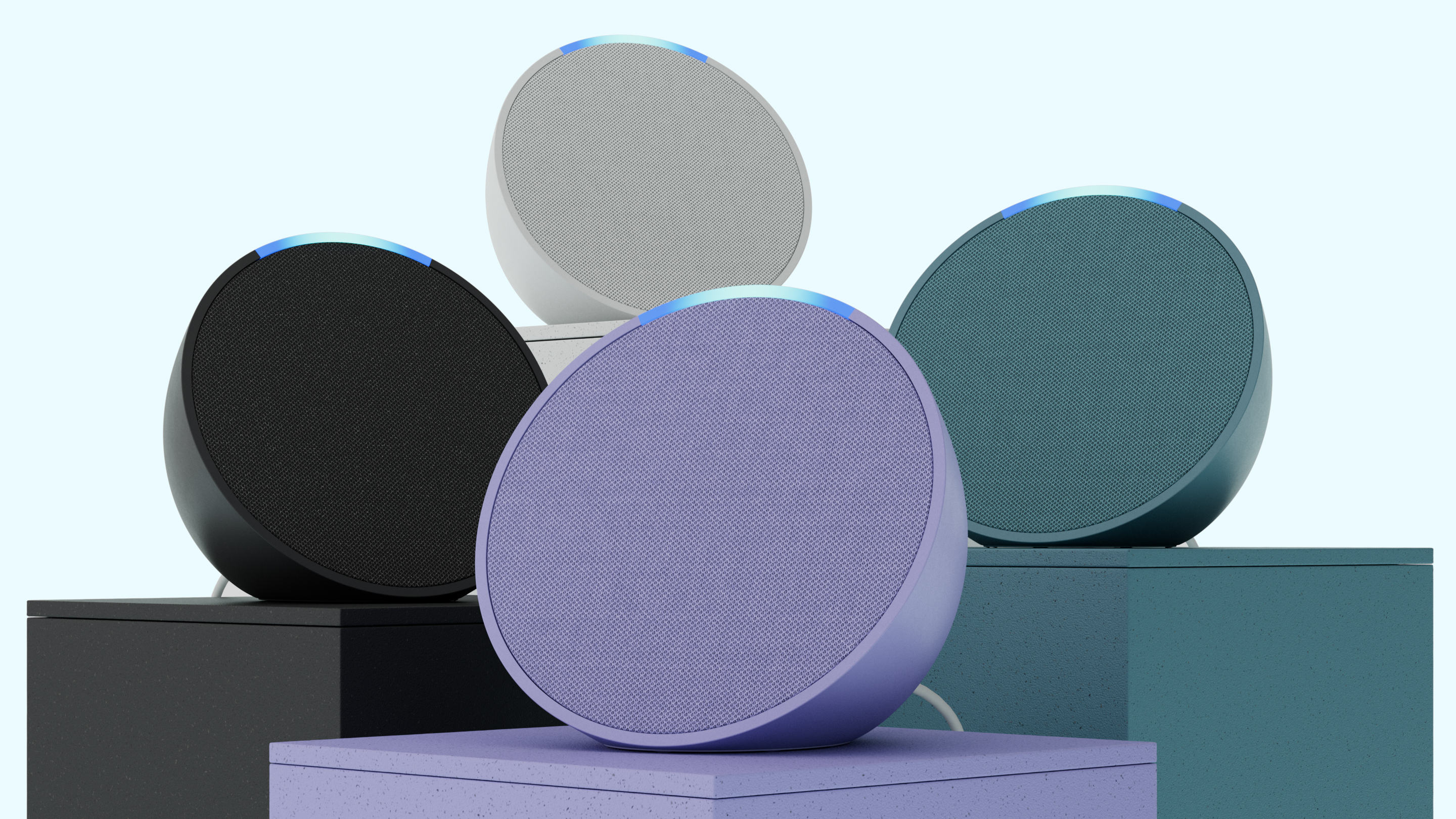 Four different colors of the Amazon Echo Pop speaker sat together