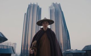 Dressed in traditional costume, the monk is passing by fragments of modern China, from high rises to super highways