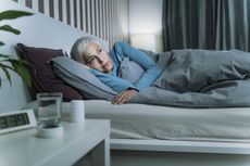 Woman Suffering from Insomnia Laying In Bed