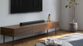 The Sony HT-X8500 soundbar pictured in a living room on a TV cabinet
