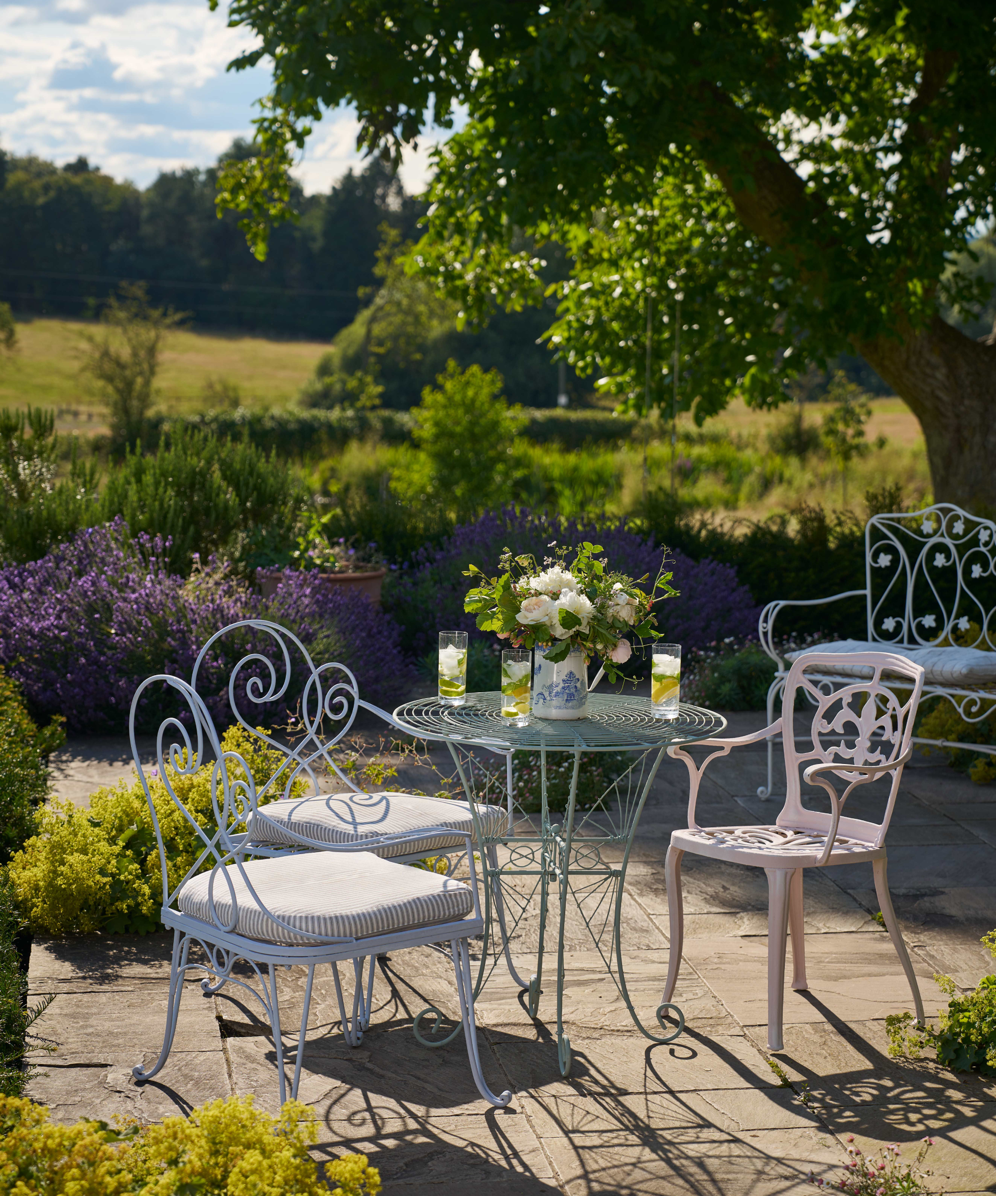patio area with pink and blue ornate painted bistro style patio furniture