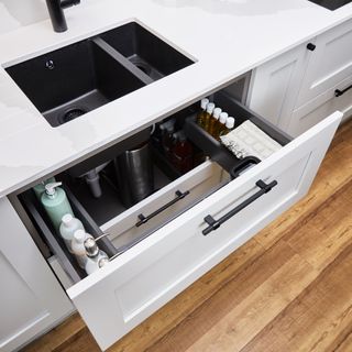 Howdens dove-grey kitchen with under sink drawer.