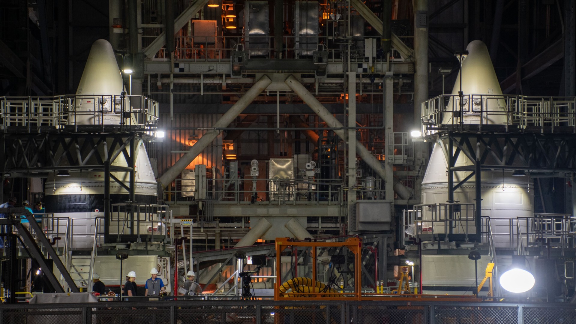 two giant white cones inside a very large warehouse