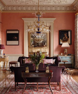 Pink walls and rug, blue cabinet, red sofa