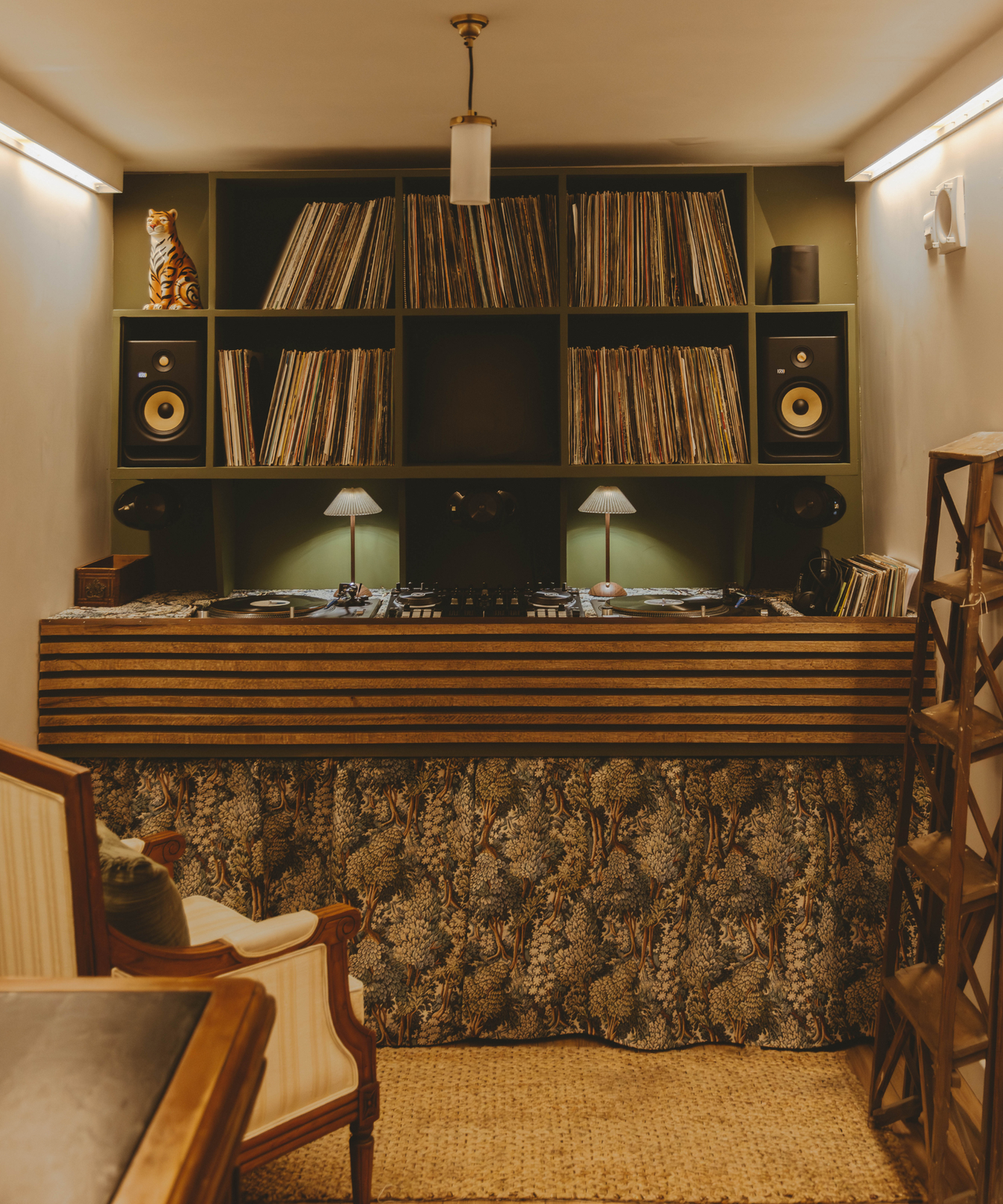 Inside the shipping container with Matthews DJ deck set up and records behind