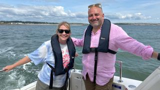 Wynne and Joanna standing on a boat and smiling