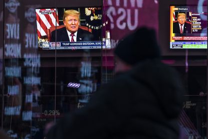 Trump's address to the nation on a TV screen in Times Square