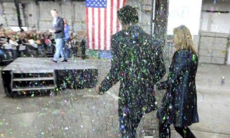 Mitt Romney and his wife are &amp;quot;glitter bombed&amp;quot; in Minnesota: A Colorado college student is the first person to be criminally charged for the sparkly stunt. 