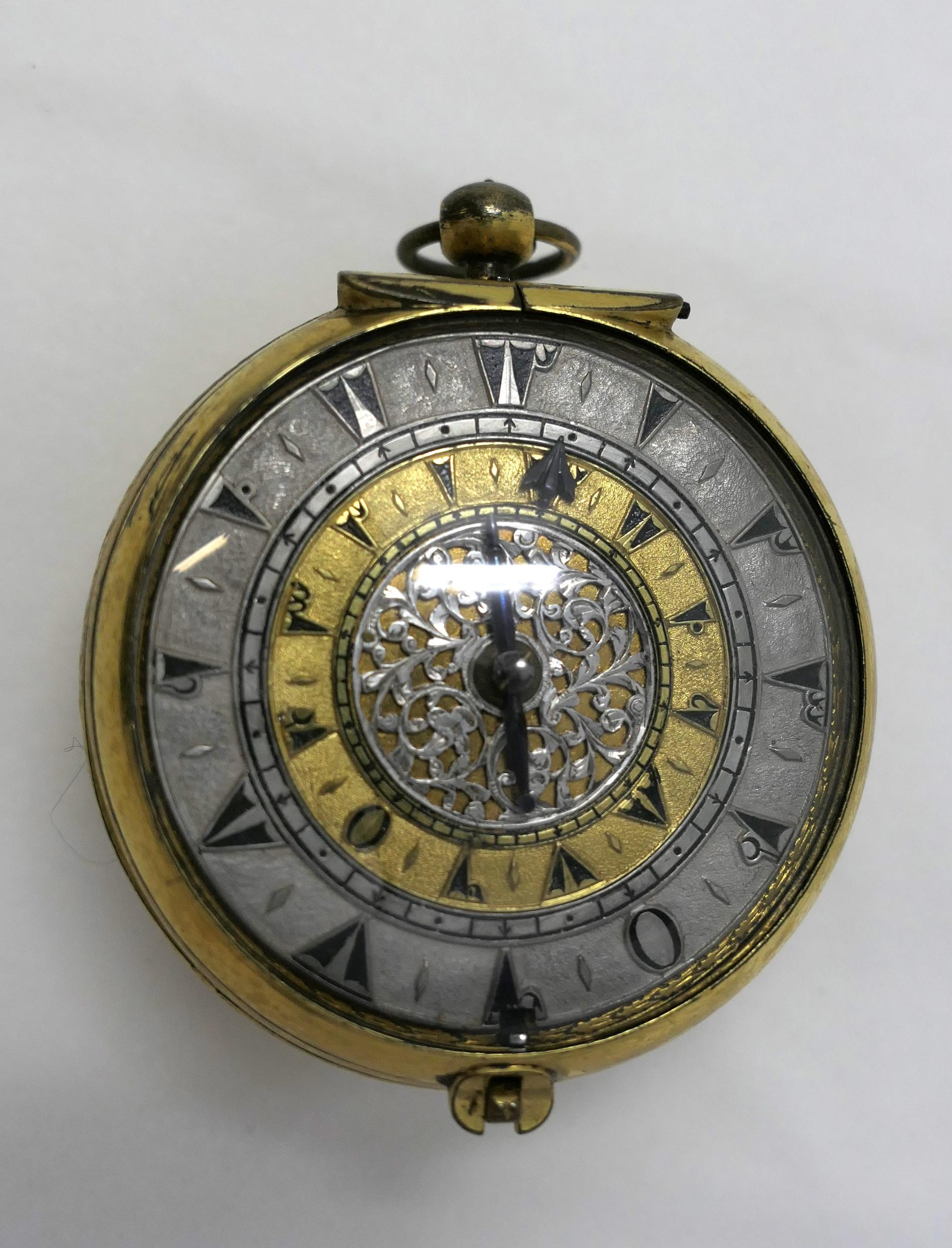 Round, gilded alarm-clock watch