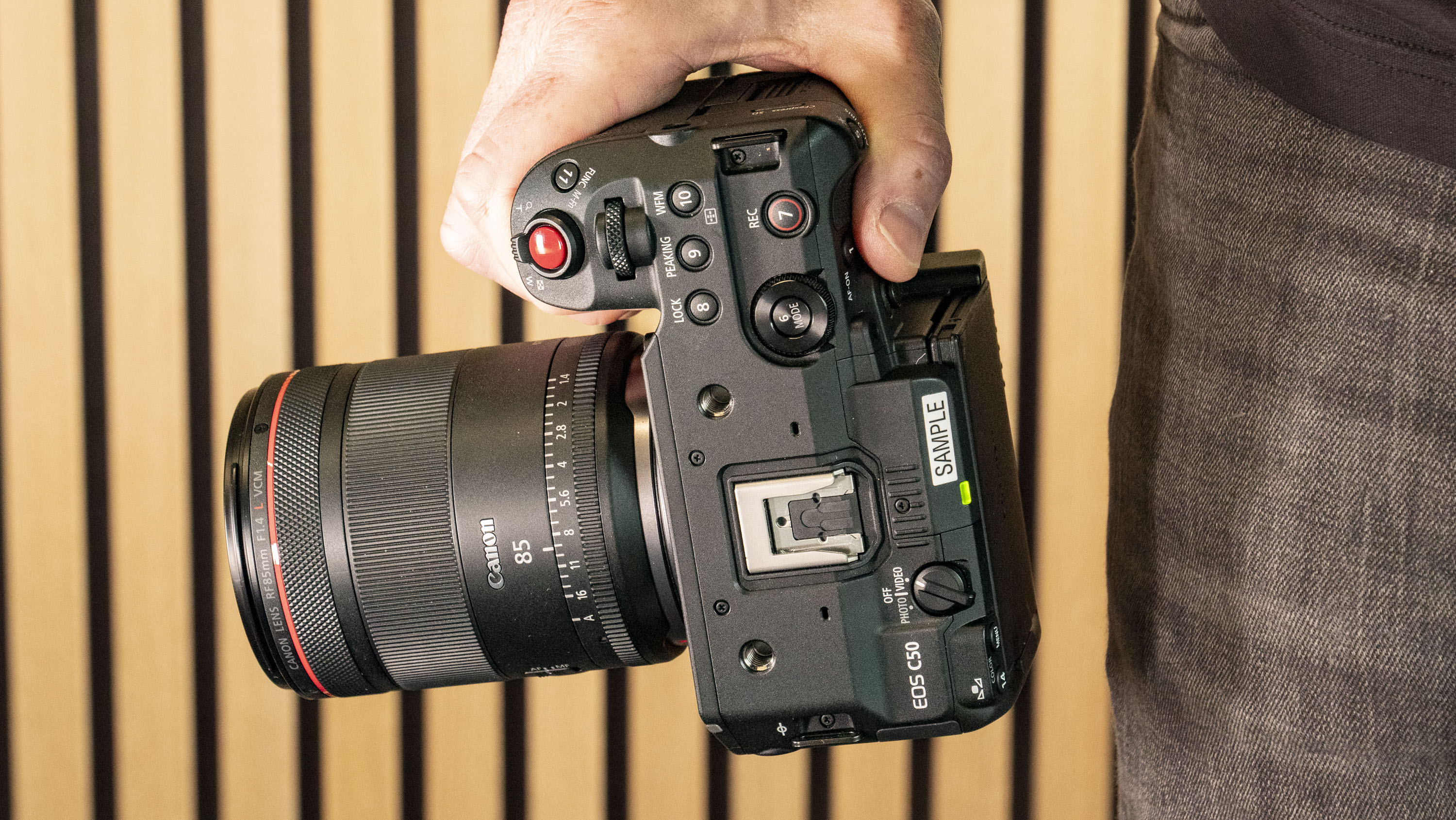 Canon RF 85mm F1.4L VCM lens attached to the Canon EOS C50 camera, in photographer's hands