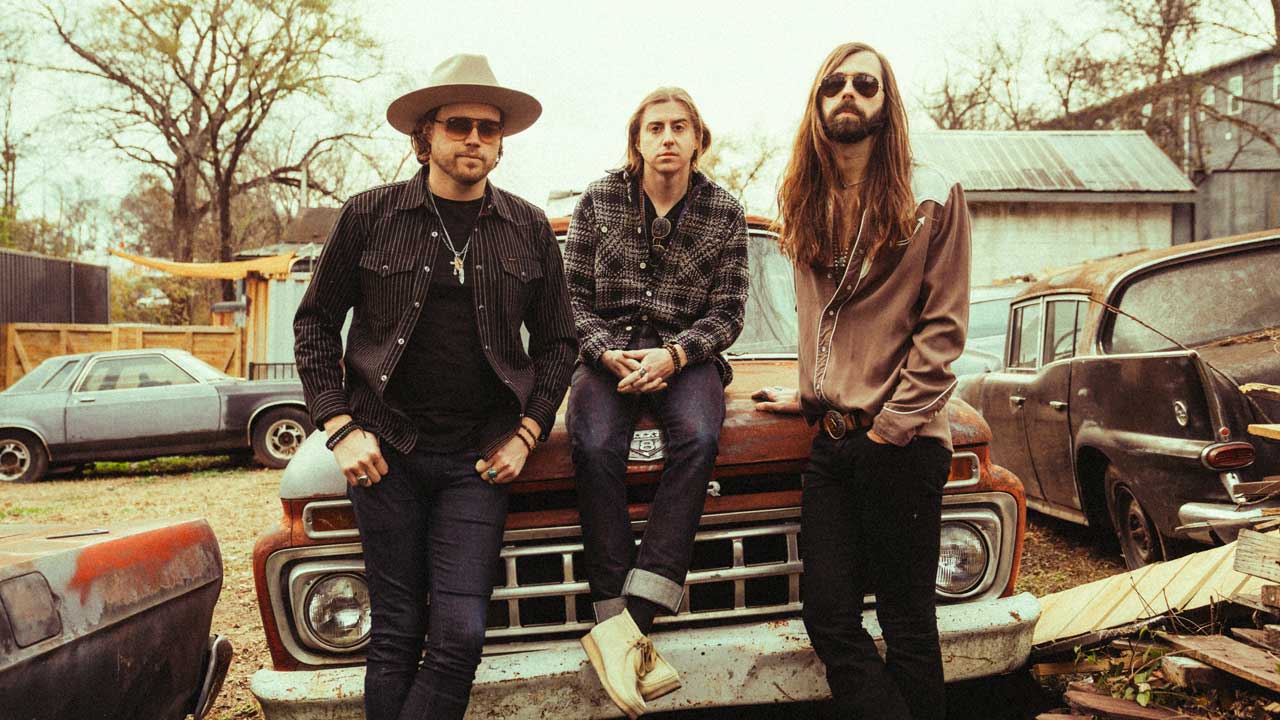 A Thousand Horses on the hood of a car in a scrapyard