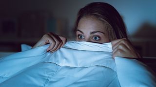 Woman scared in bed
