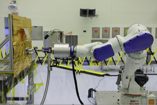 The RROxiTT industrial robot performs a test to refuel satellites on the ground, while controlled from halfway across the country. Here, the robot is based at NASA's Kennedy Space Center in Florida, but controlled from the agency's Goddard Space Flight Center in Maryland.
