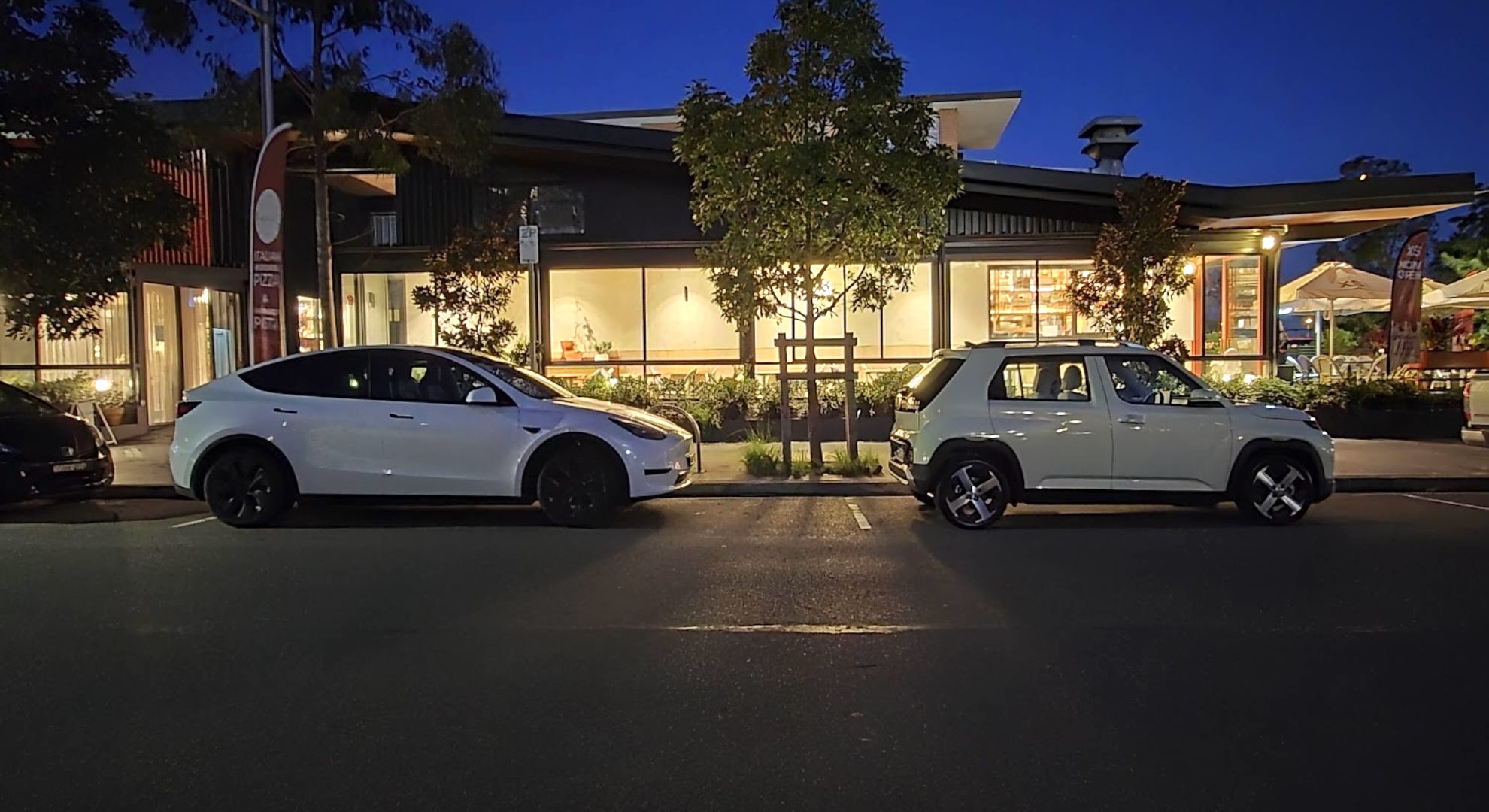 The Hyundai Inster parked in front of a Tesla Model Y