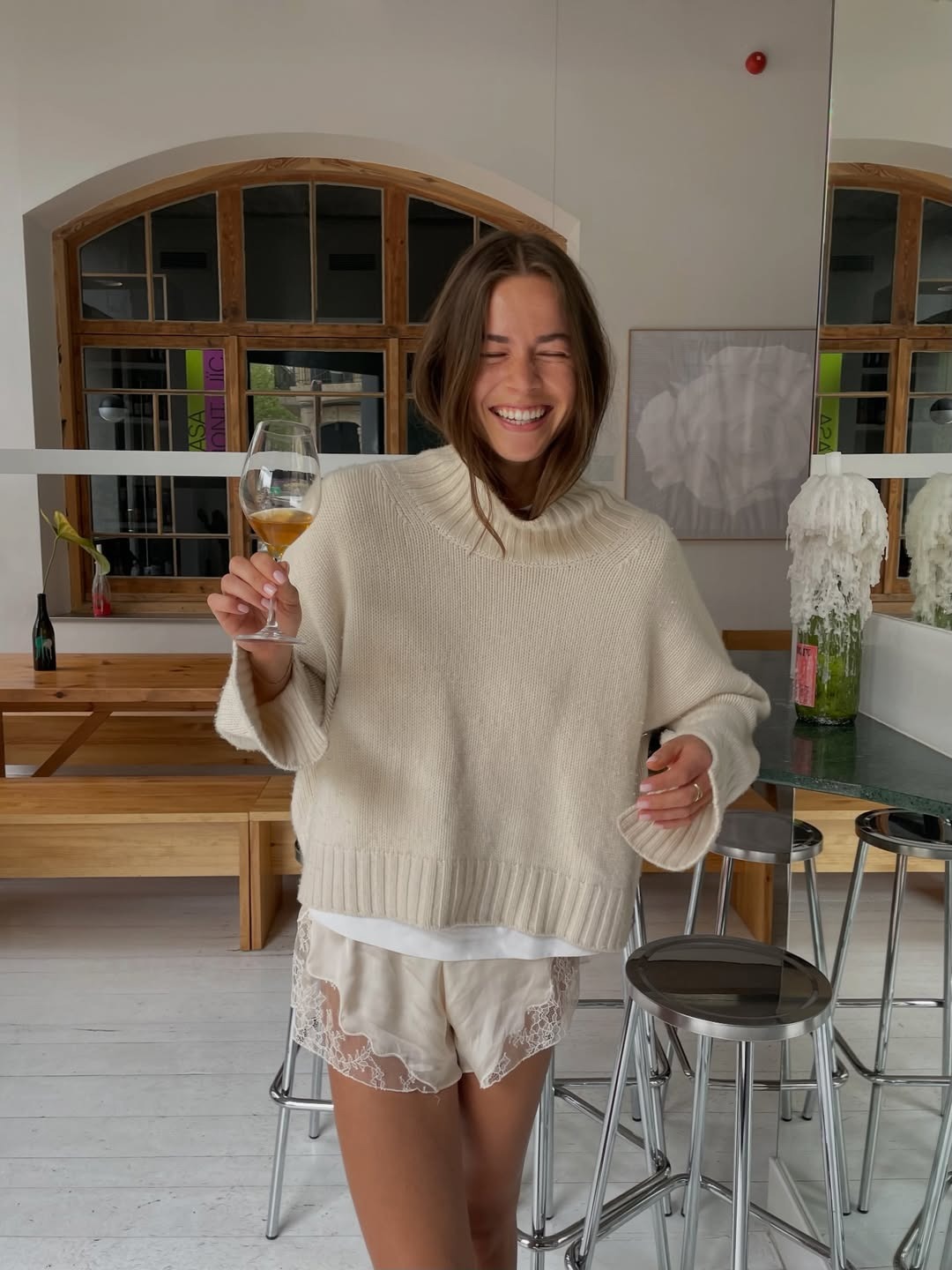 Woman in a sweater and lace-trim shorts.