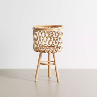 A natural rattan planter on legs