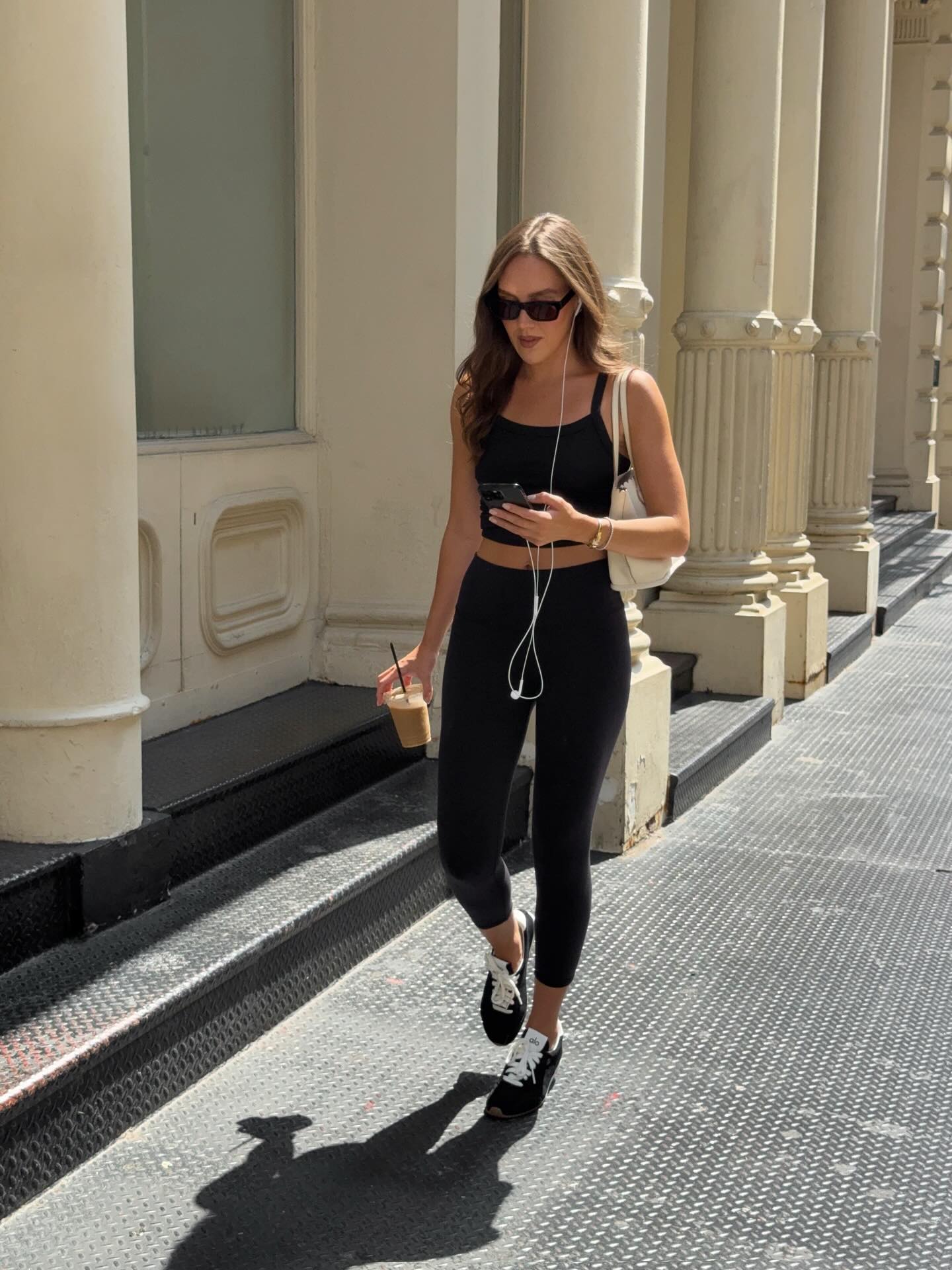 An image of @emmaleger wearing 7/8 leggings, one of the biggest leggings trends for 2026, with low-profile trainers and a matching crop top.