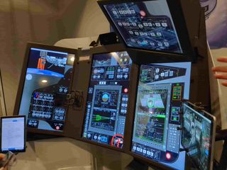 a cluster of screens showing data and displays for a space mission