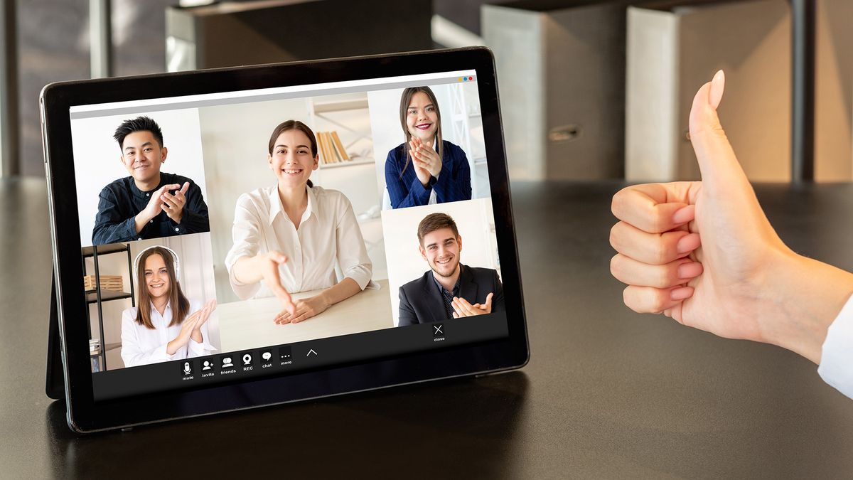 A group of young colleagues welcoming a new team member via video call