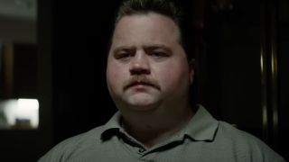 Paul Walter Hauser with mustache and wearing collared shirt in Richard Jewell