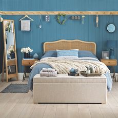 bedroom with blue colour and wooden flooring