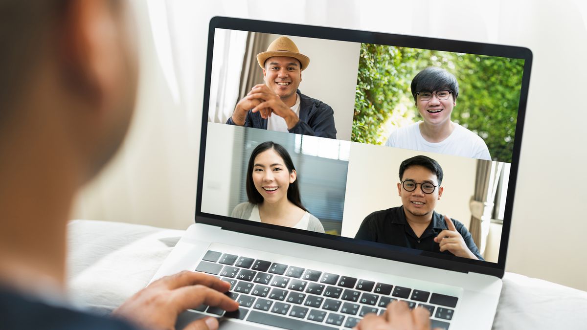 Laptop with four participants on video call