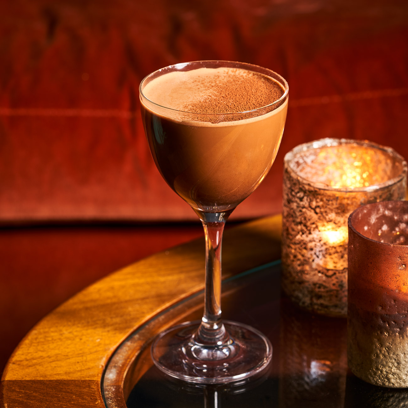 Cocktail and candles on a tray