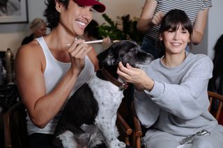 Nina Dobrev and her makeup artist along with her dog while getting ready for the Carolina Herrera show at New York Fashion Week