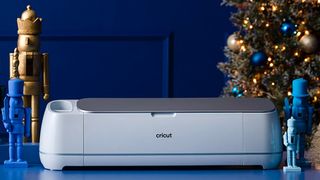 Best Cricut machines; a photo of a Cricut Maker 3 in front of a Christmas tree and wooden toy soldiers