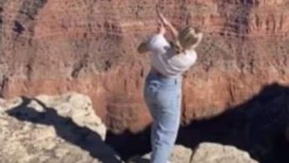 TikTok influencer Katie Sigmond pictured hitting a golf ball into the Grand Canyon