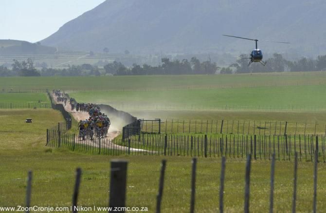 The race speeds along a gravel road section from Herold towards Oudtshoorn on the final stage