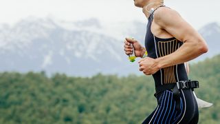 Man runs holding energy gel