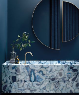 An example of bathroom color ideas showing a blue marble bathroom sink and double vanity