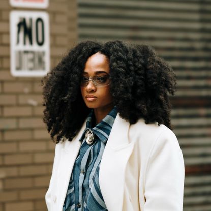 woman with curls from the best curling irons walking on the street