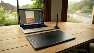 Wacom Intuos Pro Medium on a desk with Macbook