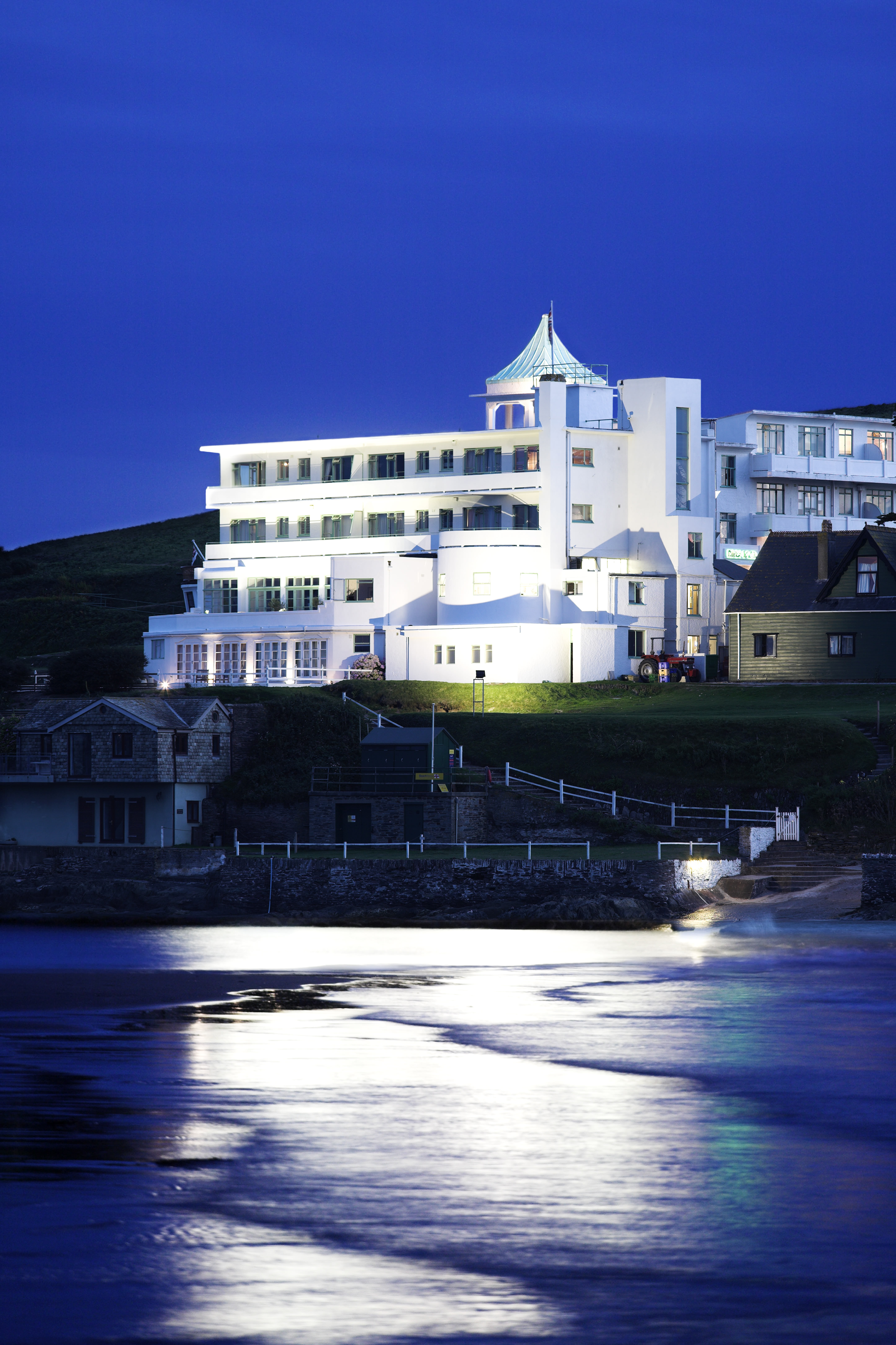White Art Deco facade on the coastline, photographed at nighttime