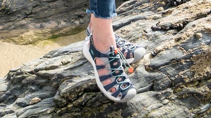 best walking sandals: Woman wearing Keen Astoria West sandals on a beach