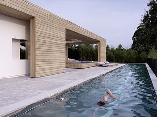 A lap pool wraps around one corner of the house