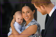 Meghan Markle holding Archie with Prince Harry at her side