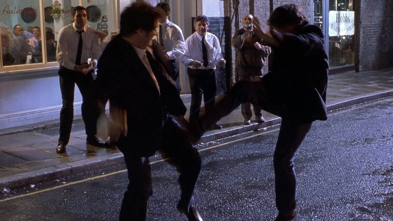 Daniel and Mark kicking each other in the street in Bridget Jones's Diary