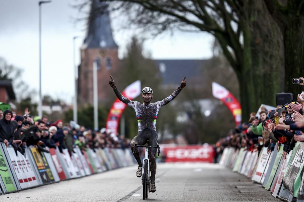 Dutch Mathieu Van Der Poel celebrates as he crosses the finish line to win the men's elite race of the cyclocross cycling event, race 4/6 in the 'Exact Cross' competition, in Loenhout, on December 29, 2023. (Photo by DAVID PINTENS / Belga / AFP) / Belgium OUT