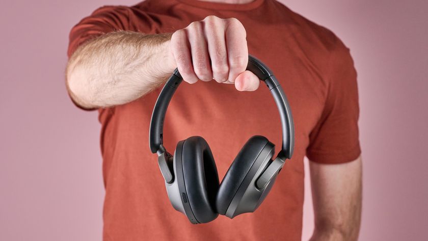 1More SonoFlow Pro HQ51 headphones held in a man's hands