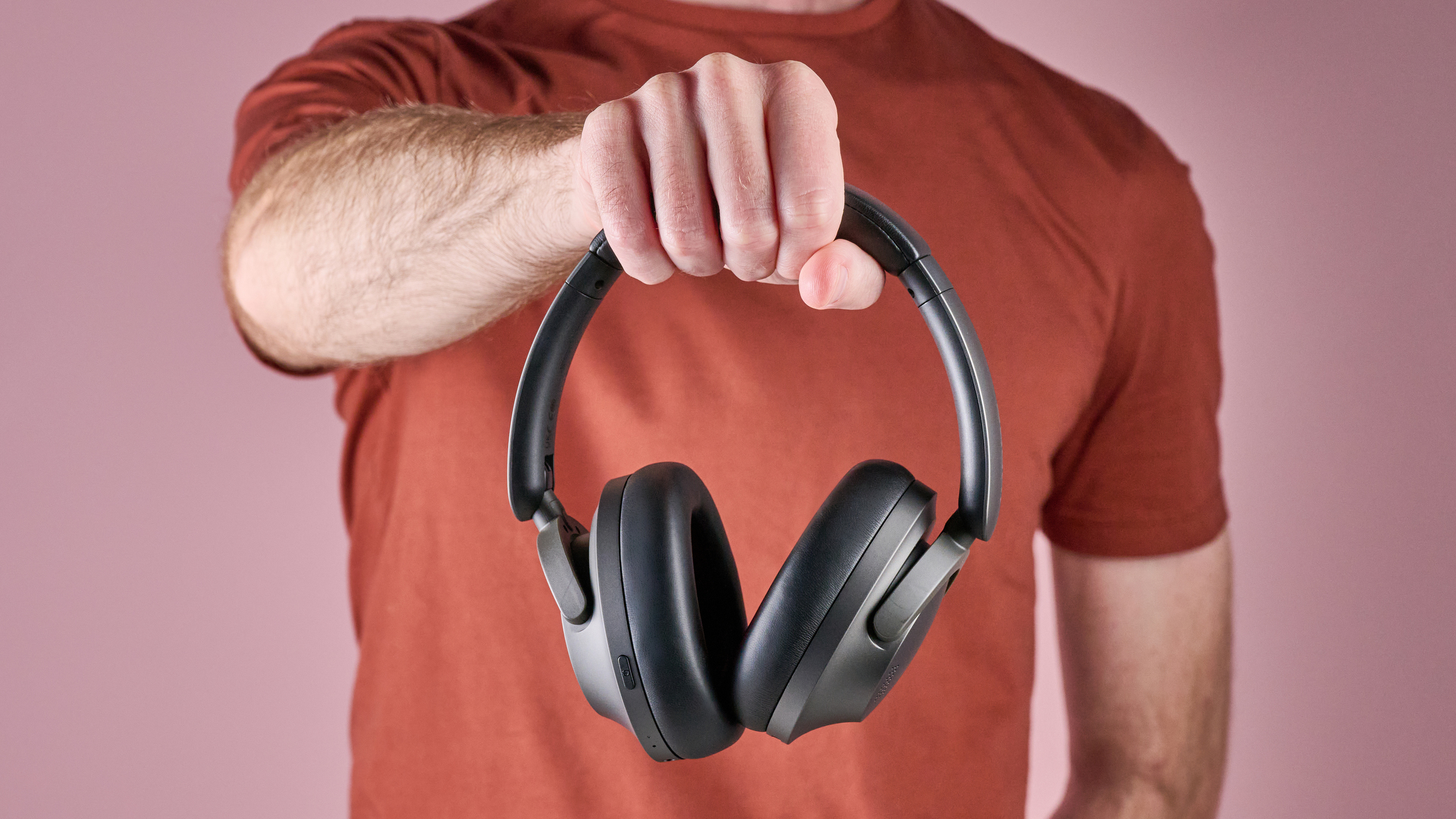1More SonoFlow Pro HQ51 headphones held in a man's hands