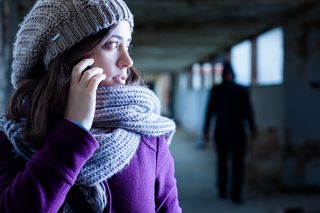 Woman on phone worried about the pervert stalking her