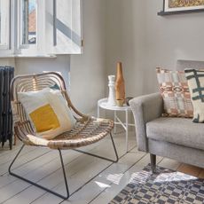 living room with rattan chair and white wall 