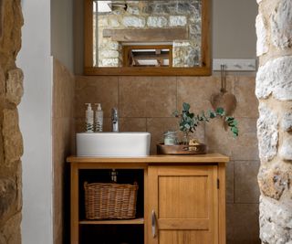 converted forge bathroom with wooden vanity and Farrow & Ball paint on the walls